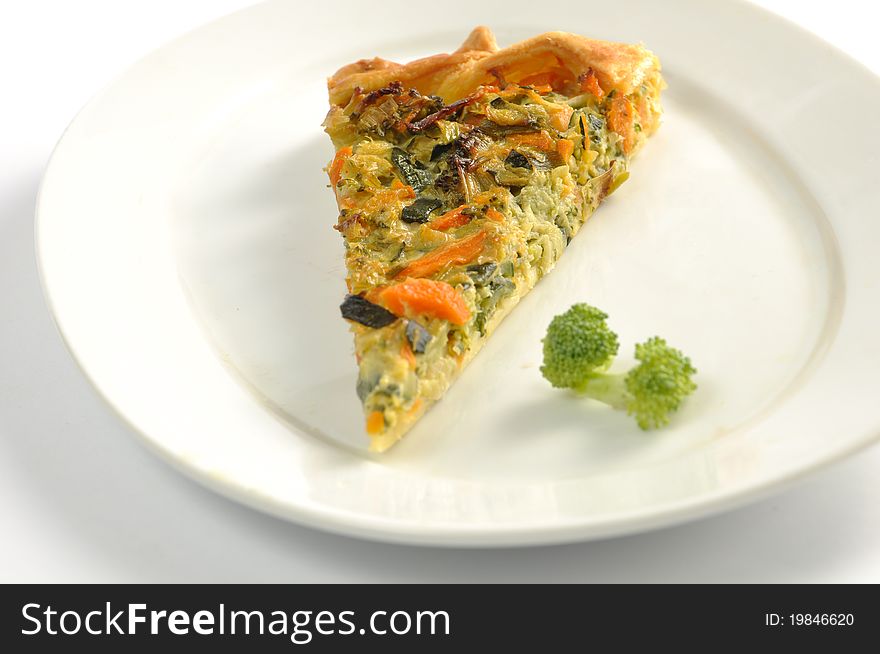 Slice Of Vegetable Pie On A White Dish
