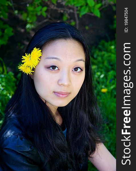 Asian Girl With Dandelion Flower In Hair