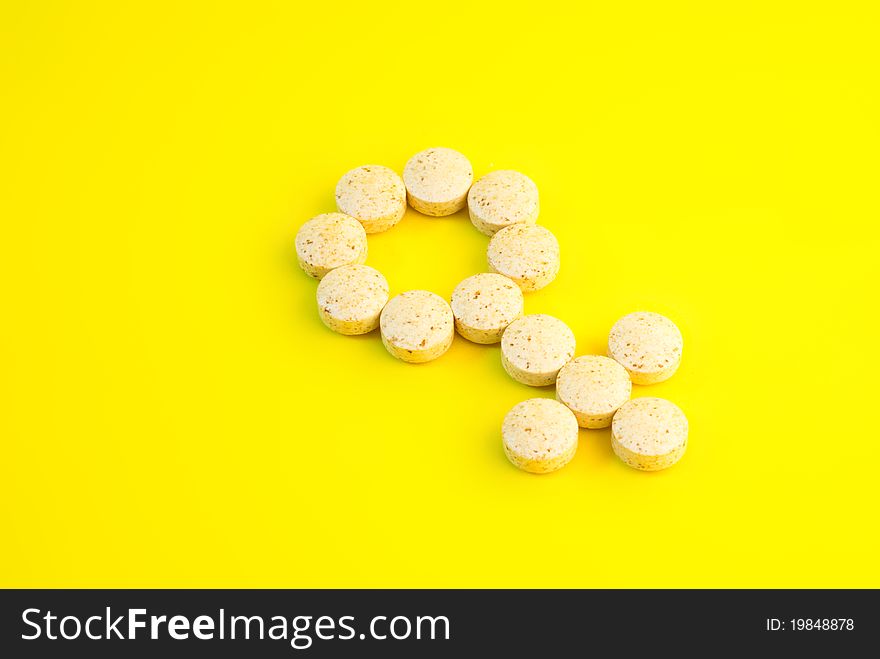 Dietary supplements on yellow background, close-up shot.