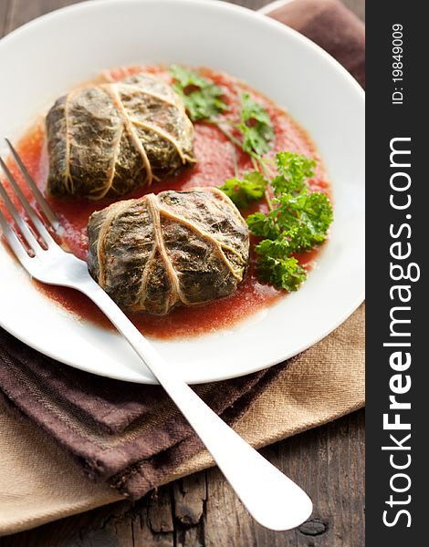 Rustic food, armenian or greek dolmades wrapped with rhubarb leaves, meat and rice. Rustic food, armenian or greek dolmades wrapped with rhubarb leaves, meat and rice