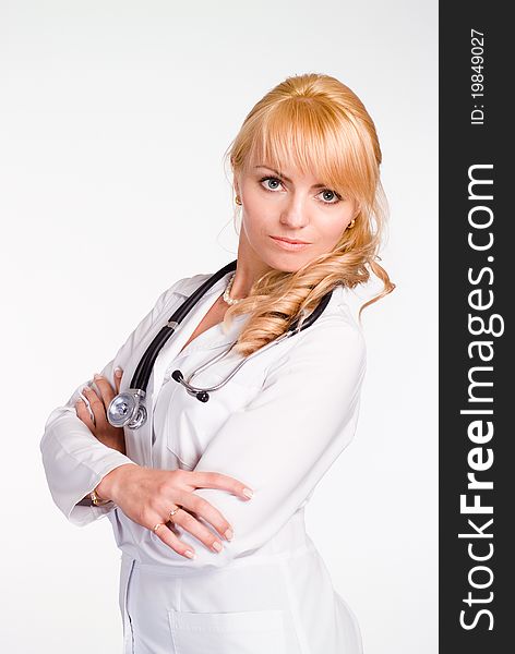 Portrait of a cute doctor standing on a white. Portrait of a cute doctor standing on a white