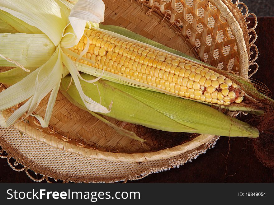 Two corn cobs in basket. Two corn cobs in basket