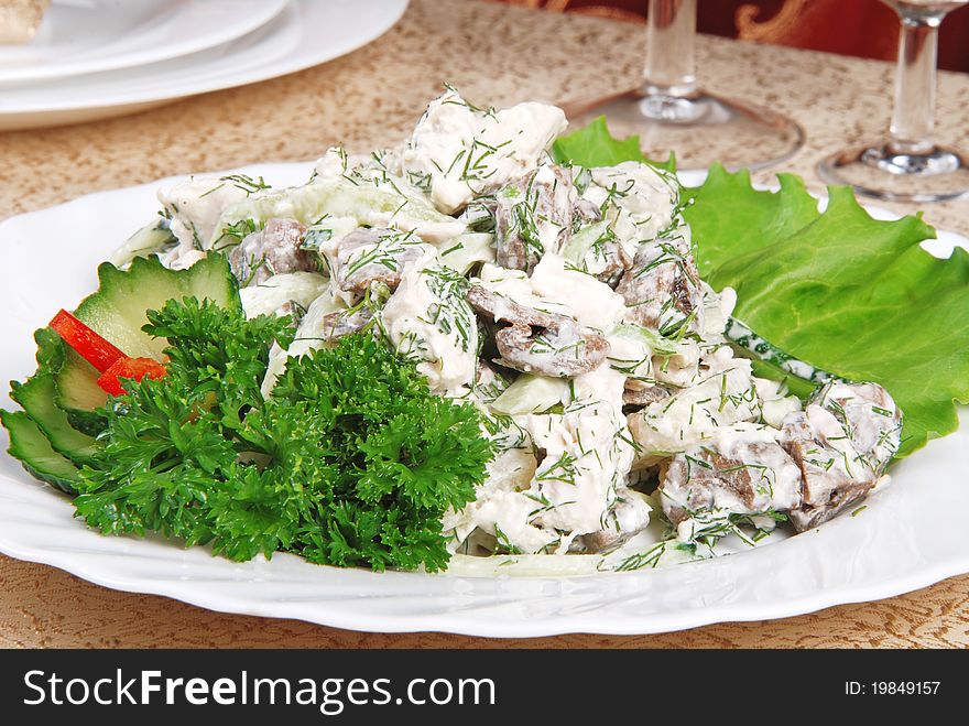Meat salad on white plate. Restaurant. Meat salad on white plate. Restaurant