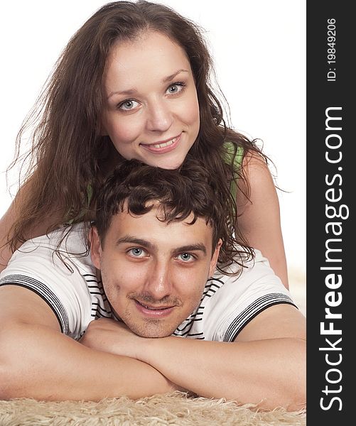 Nice young couple lying on a carpet. Nice young couple lying on a carpet