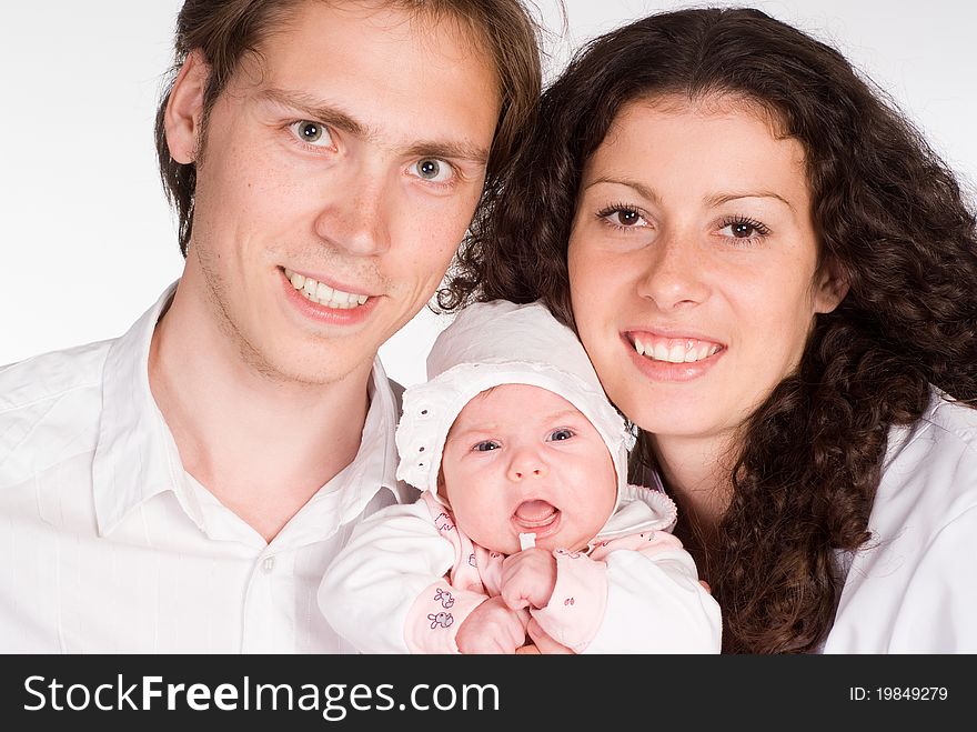 Happy young family with  newborn on a white. Happy young family with  newborn on a white