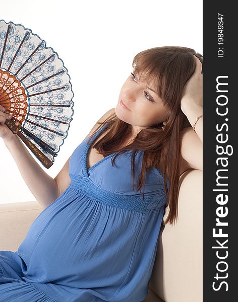 Pregnant girl in a dress with fan. Pregnant girl in a dress with fan