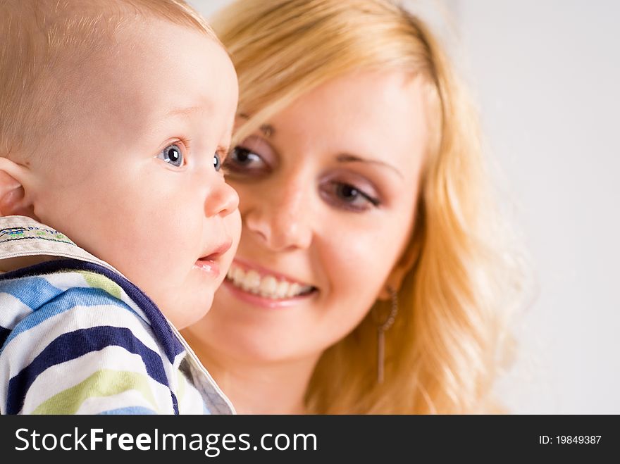 Cute mom with her baby on a white. Cute mom with her baby on a white