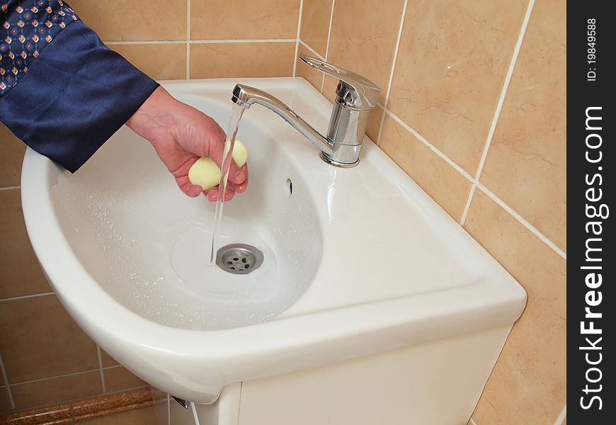A Person Washing Their Hand .