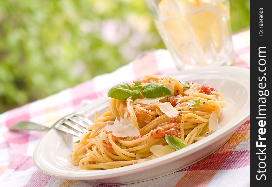 Spaghetti with a tomato sauce, cheese and a basil. Selective focus