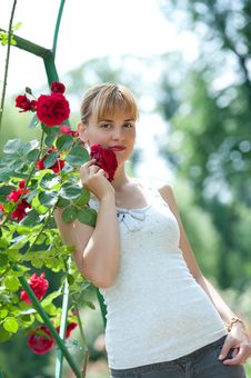 Young Pretty Woman Holding And Smelling Red Rose. Royalty Free Stock Photo