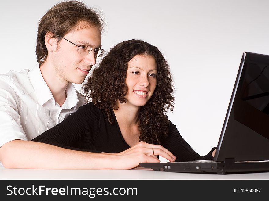 Happy young couple works with a laptop. Happy young couple works with a laptop