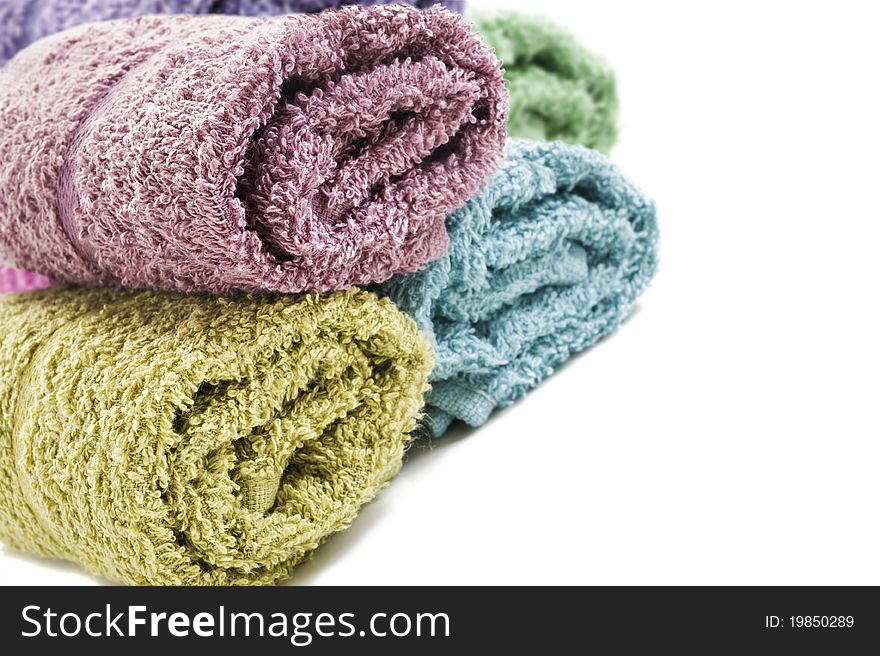 Fresh rolled up towels on a white background