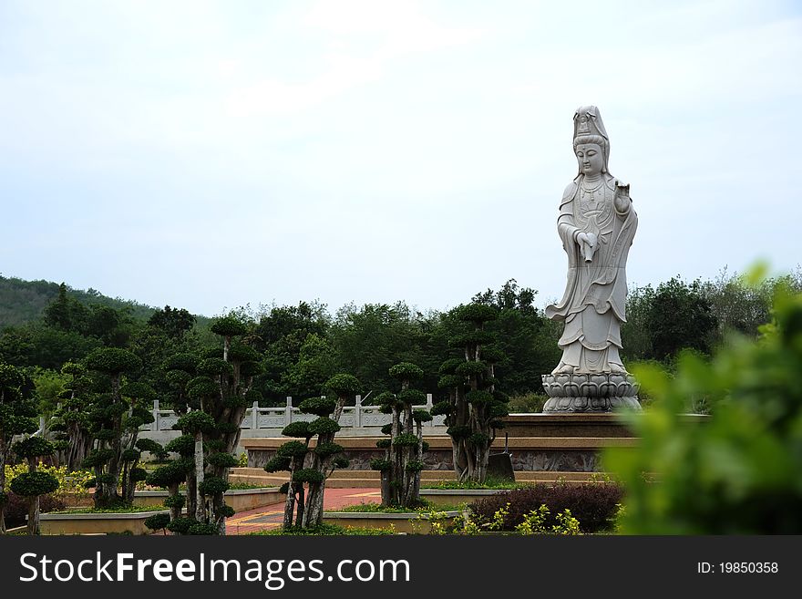 Guan yin statue with sky as background