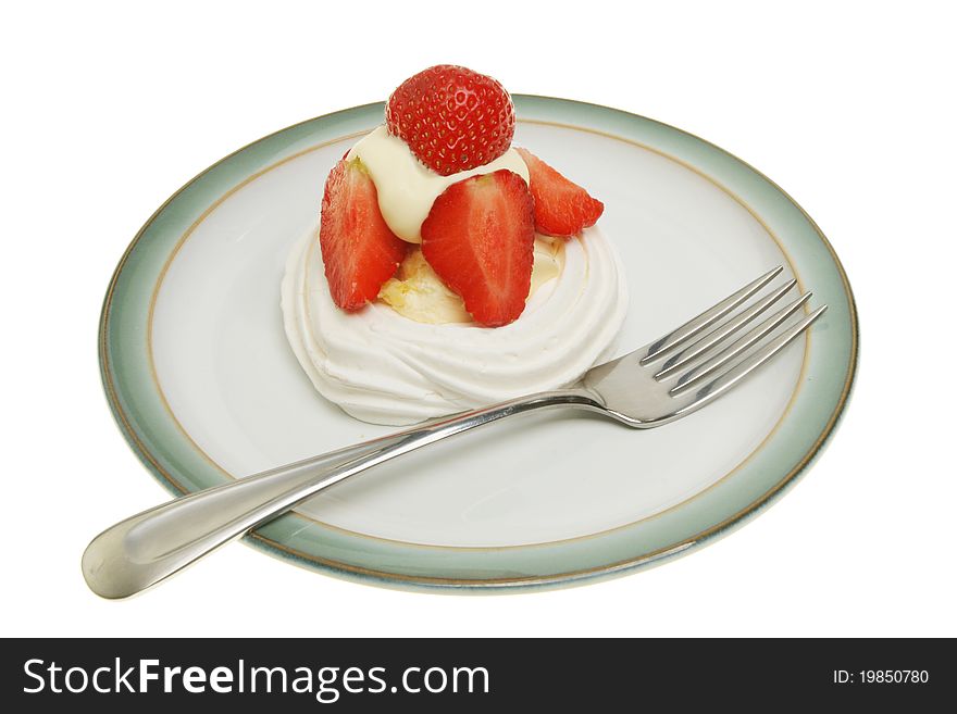 Strawberry and cream meringue on a plate with a fork isolated against white. Strawberry and cream meringue on a plate with a fork isolated against white