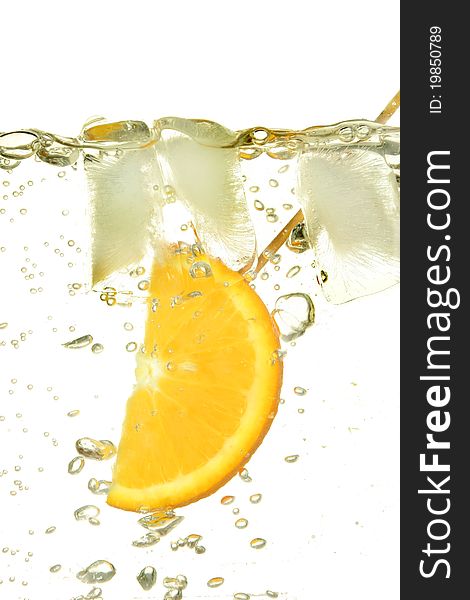 Slice of orange with ice surrounded by bubbles in water. Slice of orange with ice surrounded by bubbles in water