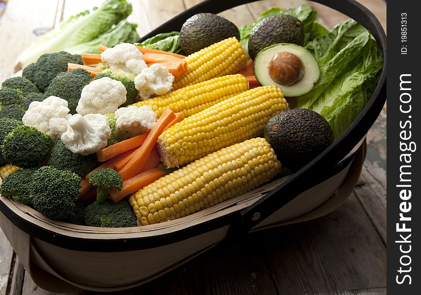 Various types of fruit and vegetables freshly harvested and laid in a garden trug. Various types of fruit and vegetables freshly harvested and laid in a garden trug