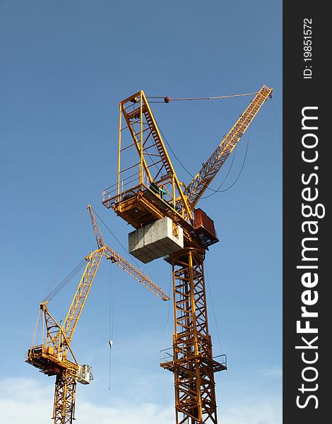 Construction crane in site with blue sky. Construction crane in site with blue sky