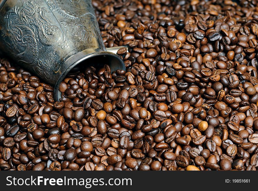 Background of coffee grains with a mug