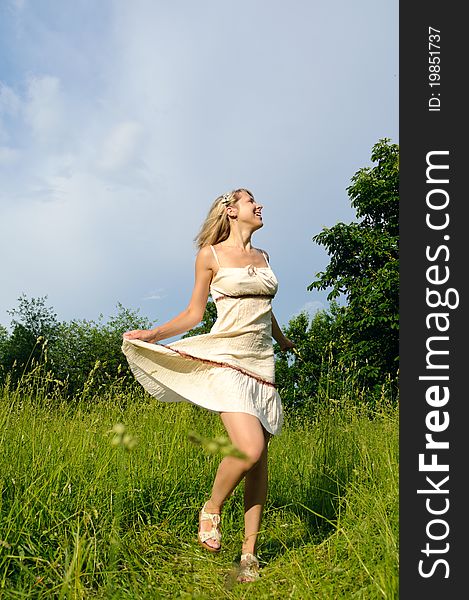 Dancing young woman on the green meadow. Dancing young woman on the green meadow