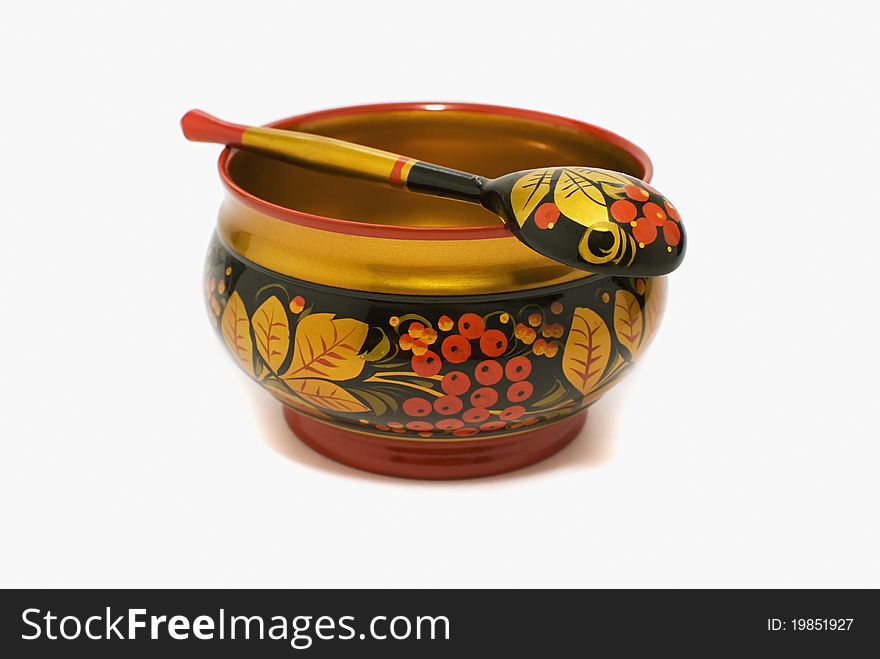 The wooden bowl is decorated in national style khokhloma. The wooden bowl is decorated in national style khokhloma