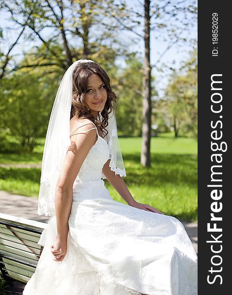 Beautiful Young Bride Sitting On Bench