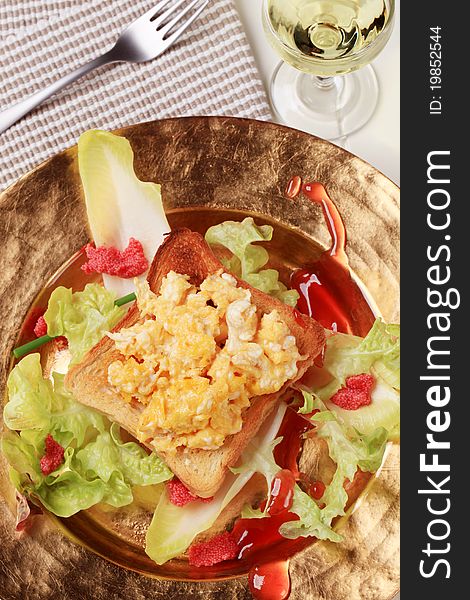 Toast and scrambled eggs on nest of fresh salad. Toast and scrambled eggs on nest of fresh salad