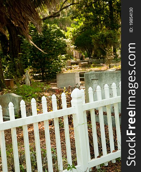 White platic picket fence surrounding historic graveyard. White platic picket fence surrounding historic graveyard