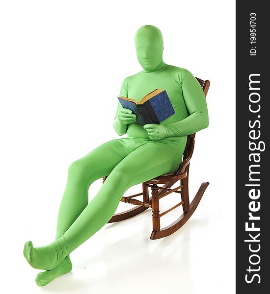 A green morphed man reading a book in a rocking chair. Isolated on white. A green morphed man reading a book in a rocking chair. Isolated on white.