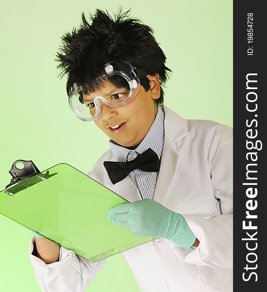 A young mad scientist in protective garb taking notes on a green clipboard. A young mad scientist in protective garb taking notes on a green clipboard.