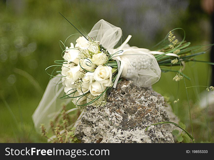 Bride bouquet on green background shot during a wedding ceremony