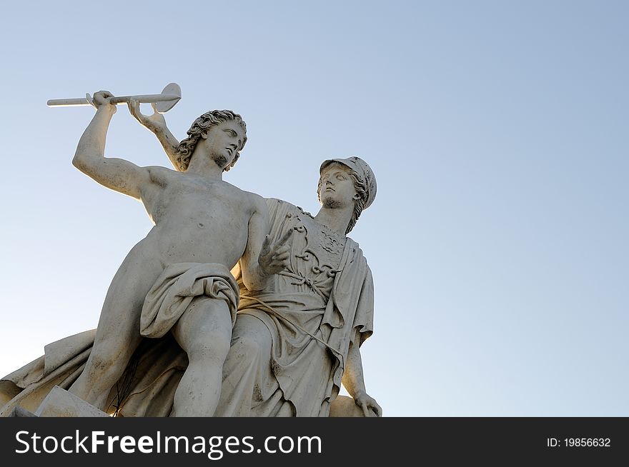 Athena teaches the young man how to use a weapon. This is one of eight statues on Schlossbruecke in Berlin, Germany.