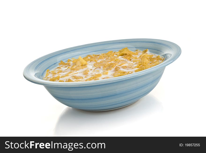 A bowl of cornflakes on a white background. A bowl of cornflakes on a white background