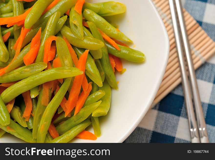 Chinese long beans cooked with carrot slices.