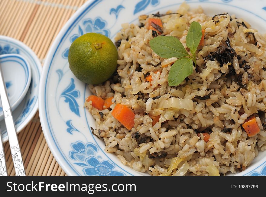 Vegetable fried rice with healthy Asian ingredients with lime on plate. Vegetable fried rice with healthy Asian ingredients with lime on plate.