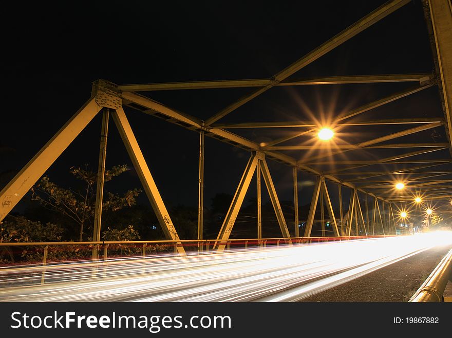 Vehicle speed over a bridge at night. Vehicle speed over a bridge at night