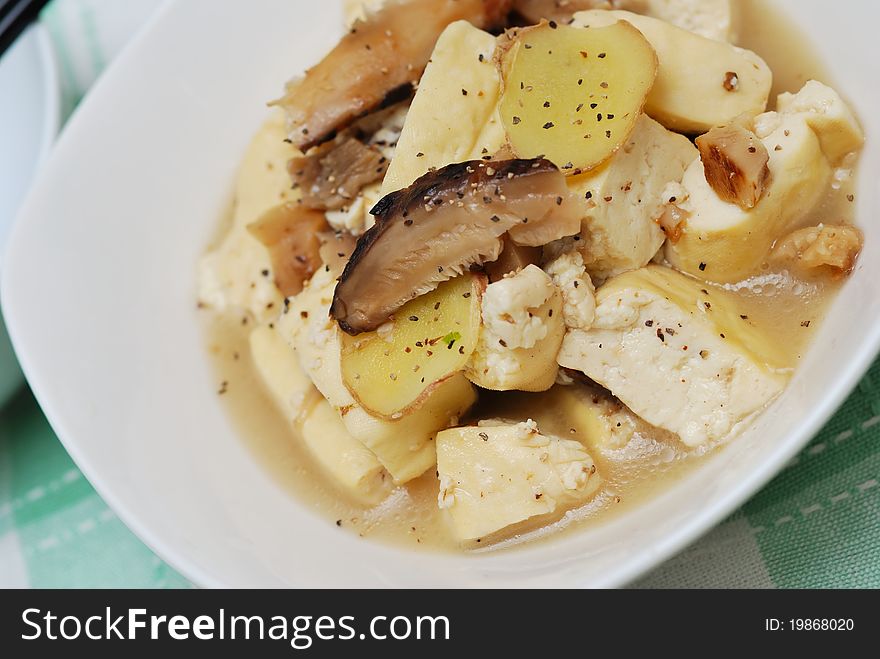 Closeup shot of Chinese style bean curd cuisine topped with black pepper.