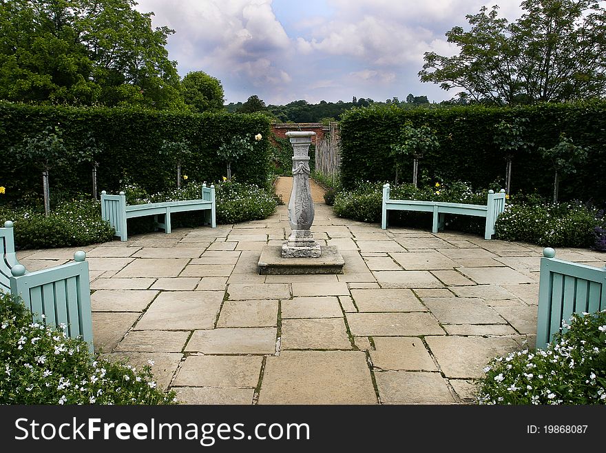 This is a country garden with a sundial as the centrepiece. This is a country garden with a sundial as the centrepiece.