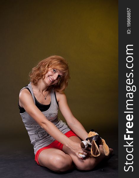 Red-haired girl with toys. Studio photography