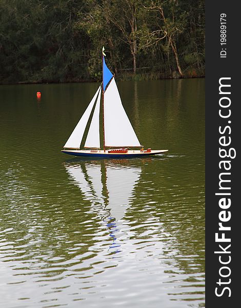 To scale sailing yacht being sailed on pond. To scale sailing yacht being sailed on pond