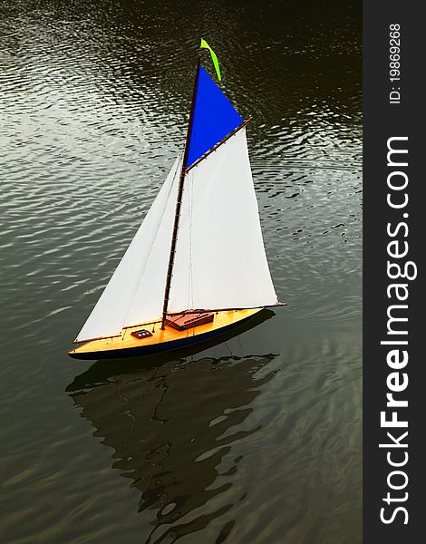 To scale sailing yacht being sailed on pond. To scale sailing yacht being sailed on pond