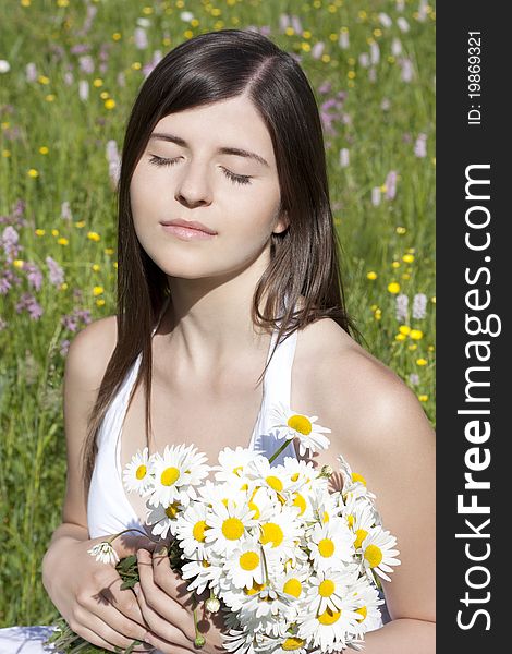 Portrait of a beautiful girl holding flowers