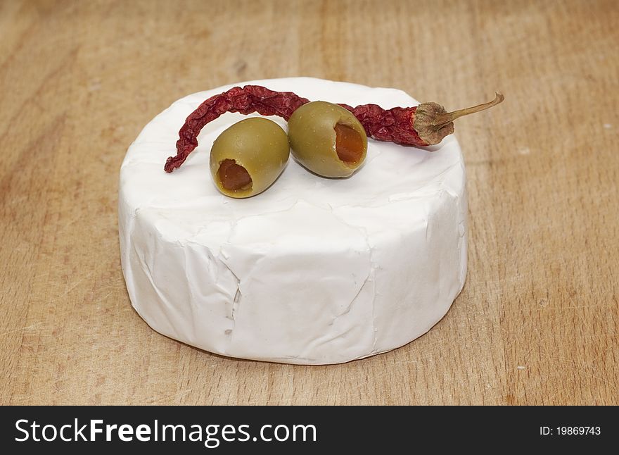 Ripened cheese type of camembert on wood