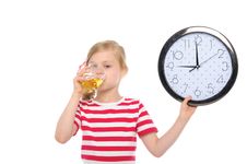Girl With Clock Drinking Juice From Glass Stock Photo