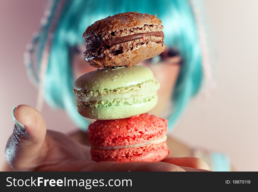 A young woman loves her sweet macaron. A young woman loves her sweet macaron.