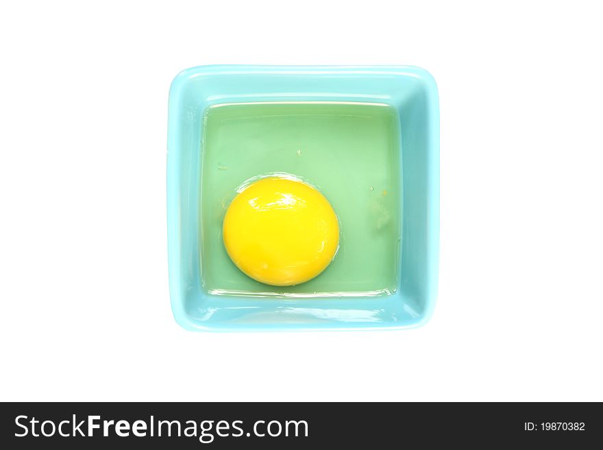 Raw egg in bowl isolated on white background