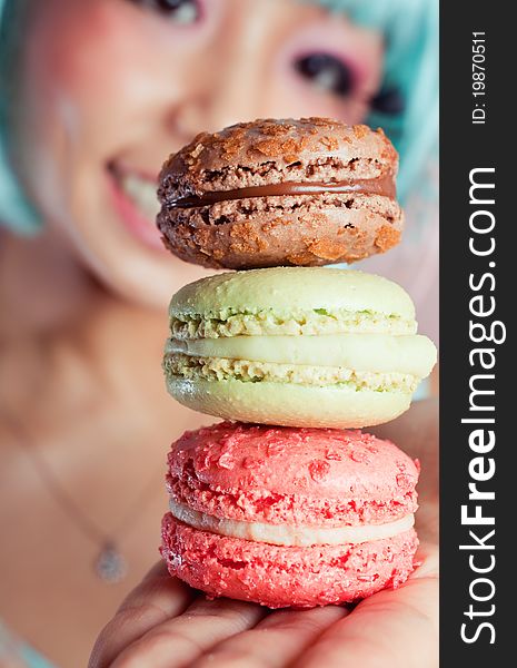 A young woman loves her sweet macaron. A young woman loves her sweet macaron.