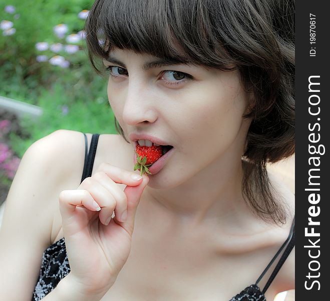 Woman eating strawberries