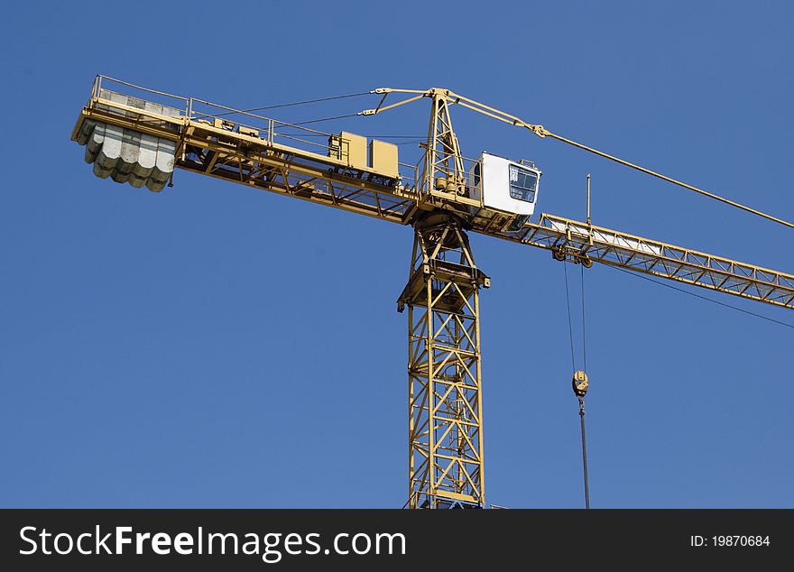 Hoisting Crane On A Background Of Blue Sky