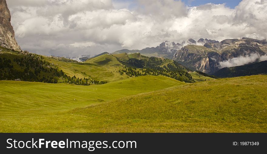 A panoramic view of European mountains and the valley. Dolomite Alps in Italy. A panoramic view of European mountains and the valley. Dolomite Alps in Italy.