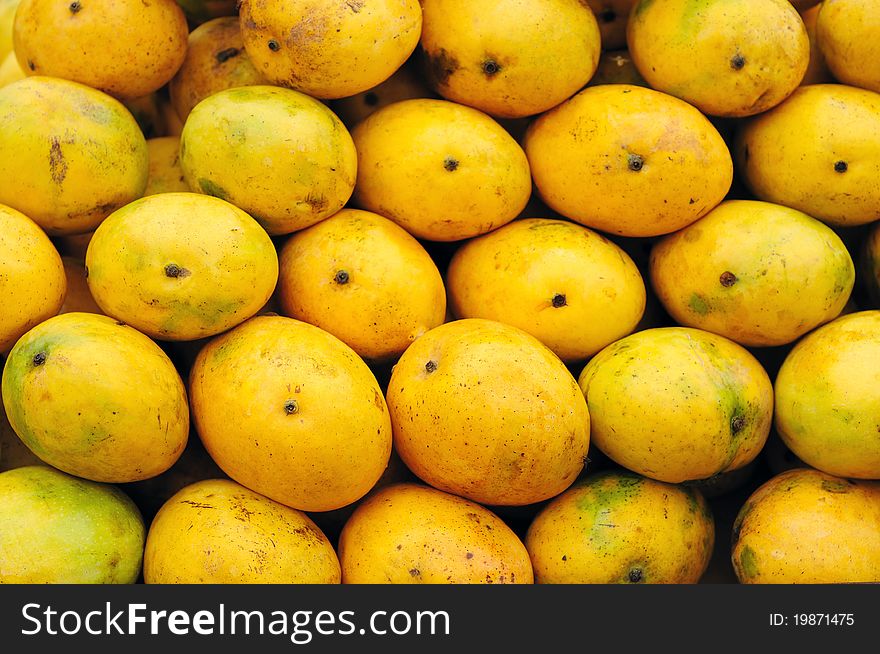 Closeup of ripe mangoes beautifully arranged for sale. Closeup of ripe mangoes beautifully arranged for sale